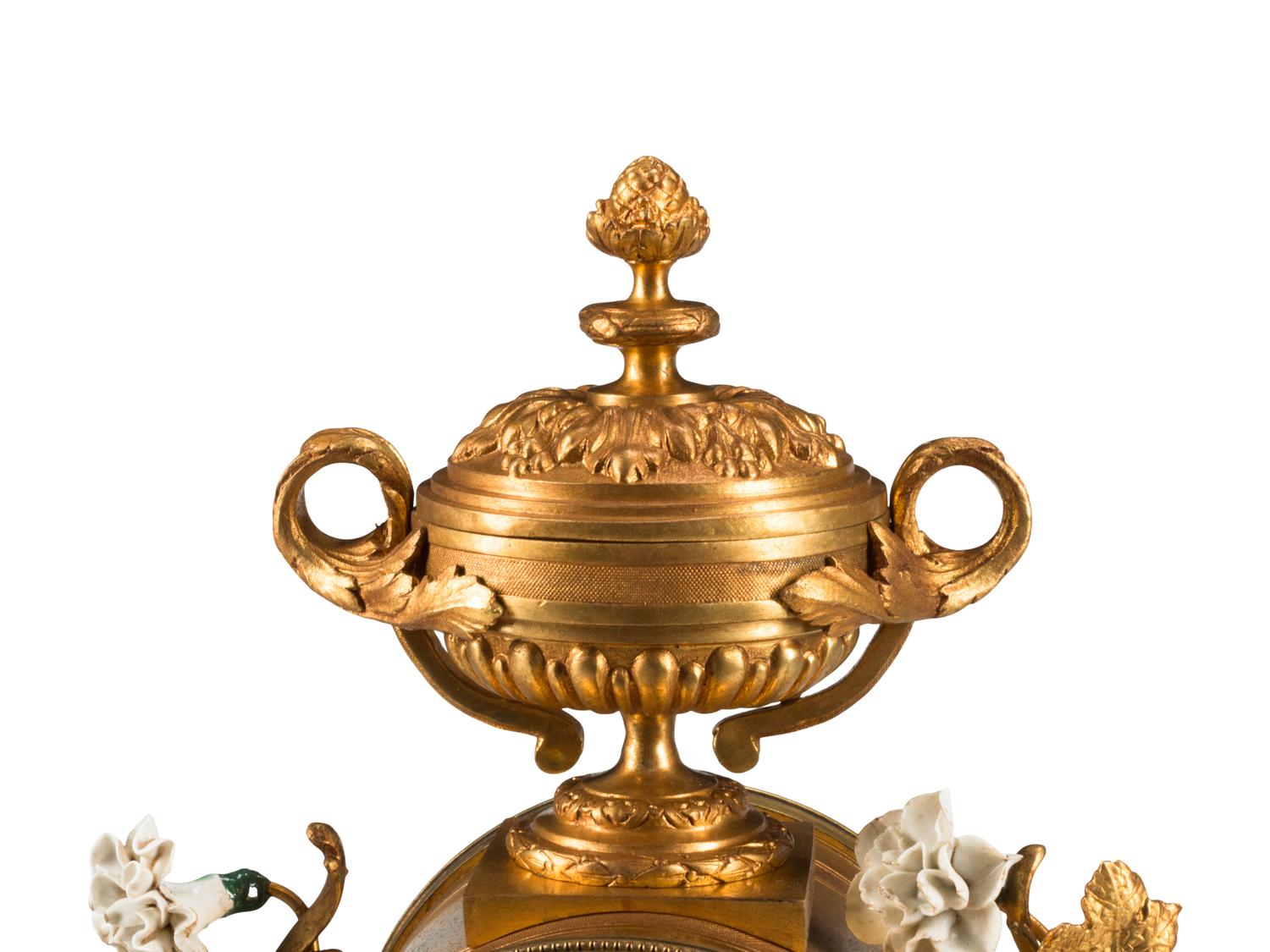 A Louis XV Style Porcelain Mounted Gilt Bronze Clock