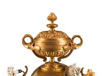 A Louis XV Style Porcelain Mounted Gilt Bronze Clock