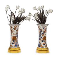 A Pair of Gilt Bronze Mounted Imari Palette Porcelain Vases with Biscuit Porcelain Tulip Arrangements