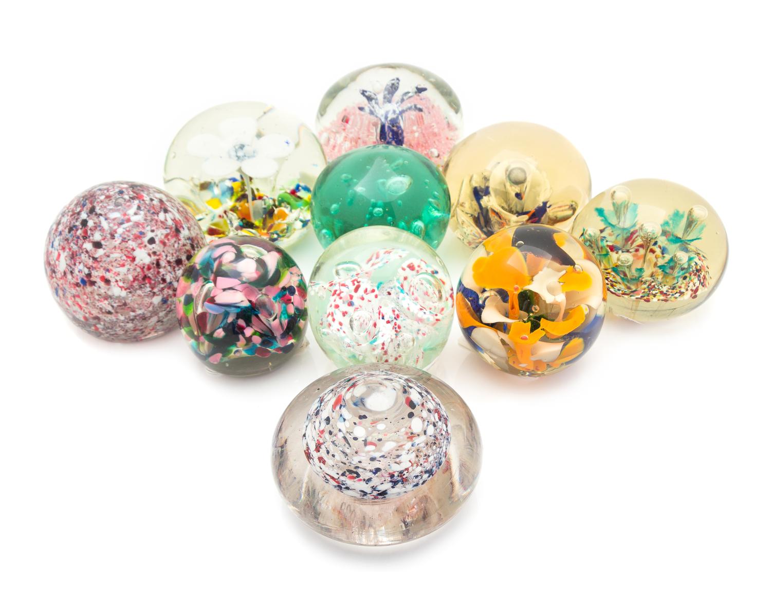 A Group of Ten Large Glass Paperweights/Doorstops Diameter of largest 5 3/4 inches