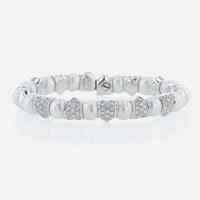 An 18K white gold, cultured pearl, and diamond bangle Italy