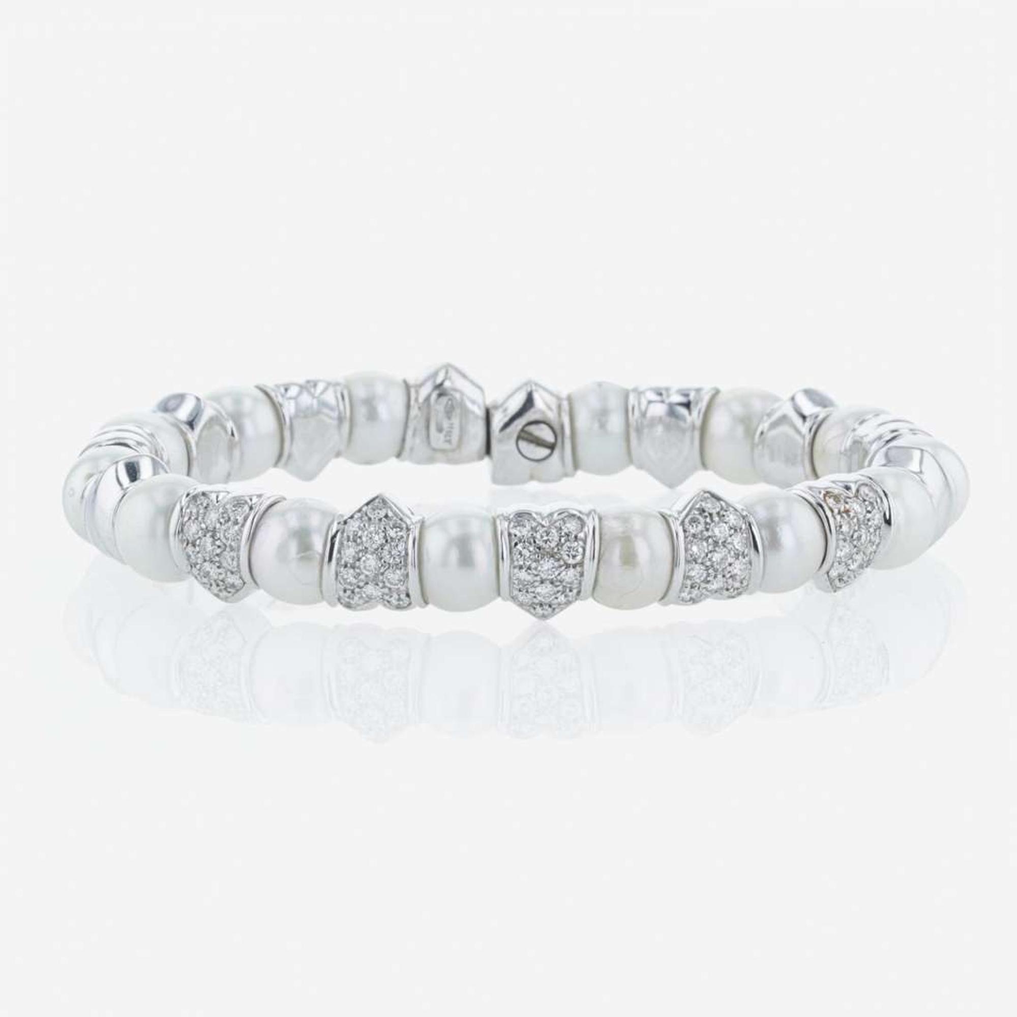 An 18K white gold, cultured pearl, and diamond bangle Italy