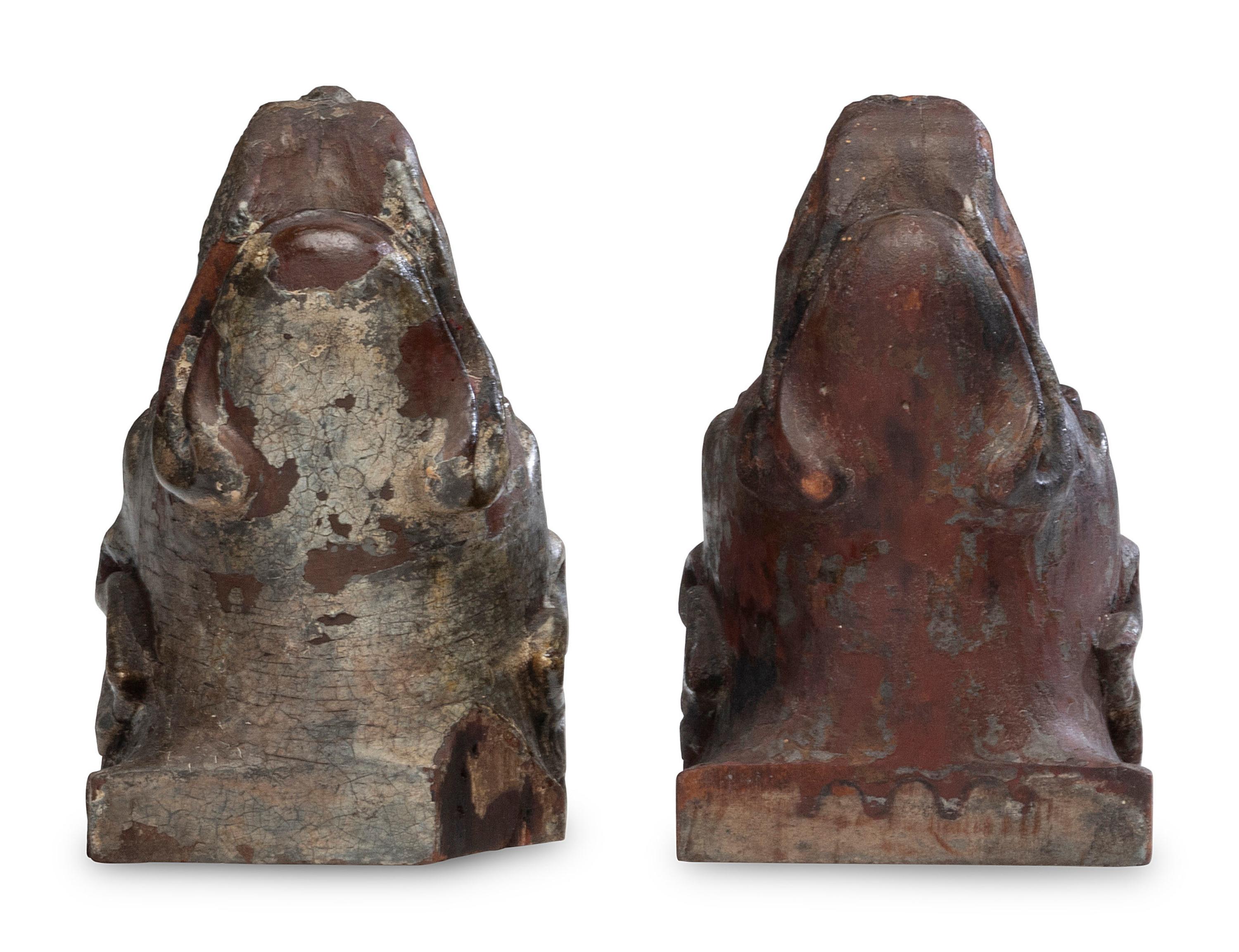 A Pair of Carved Walnut Dog-Form Wall Mounts