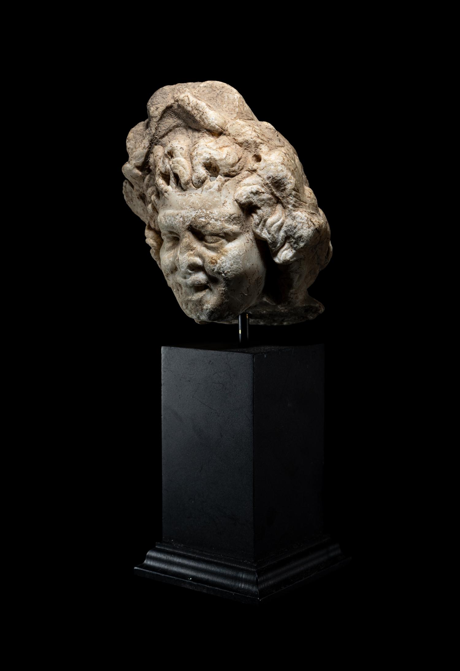 A Roman Marble Head of a Satyr