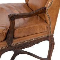 A Pair of Régence Style Leather-Upholstered Wingback Chairs