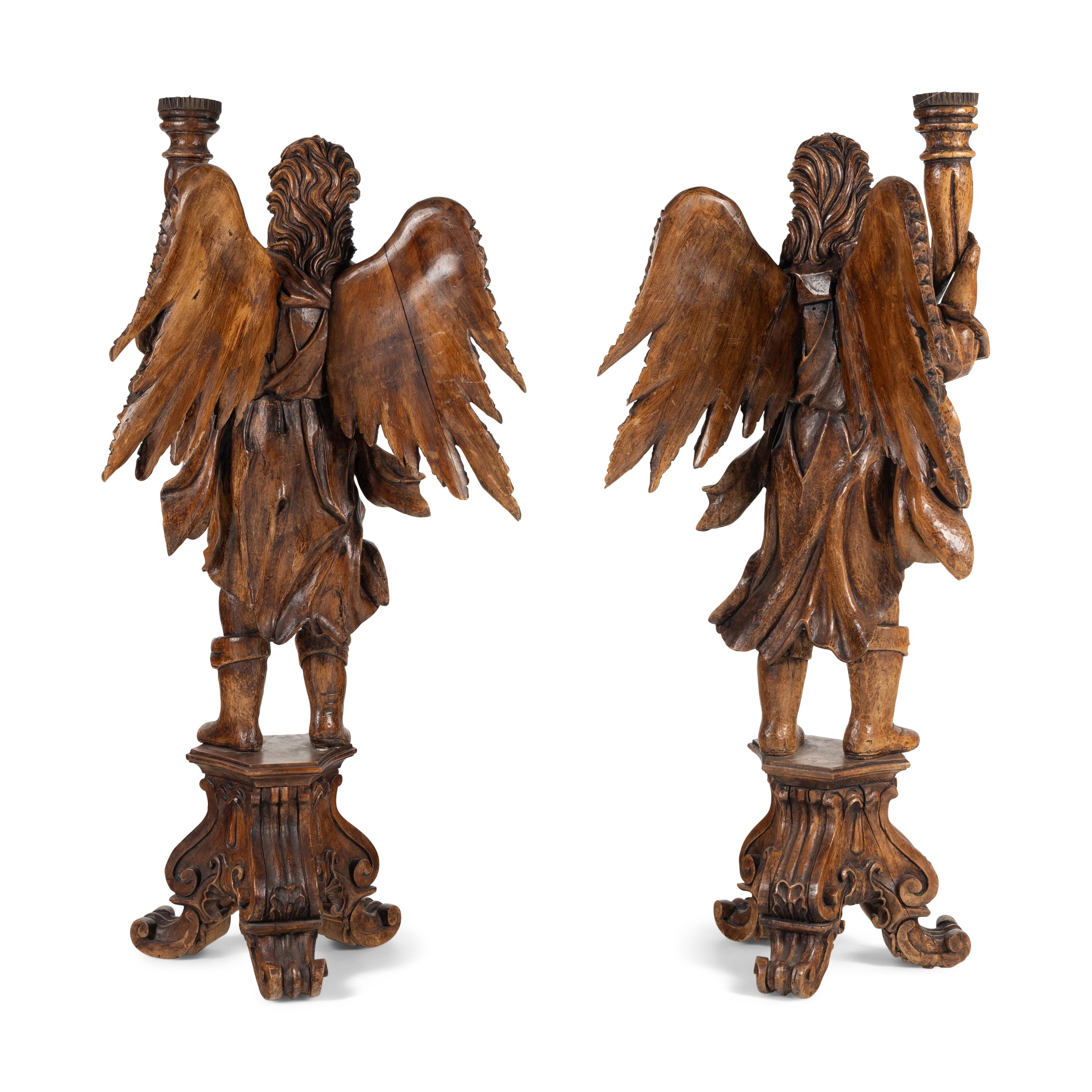 A Pair of Monumental Carved Walnut Figural Torchères