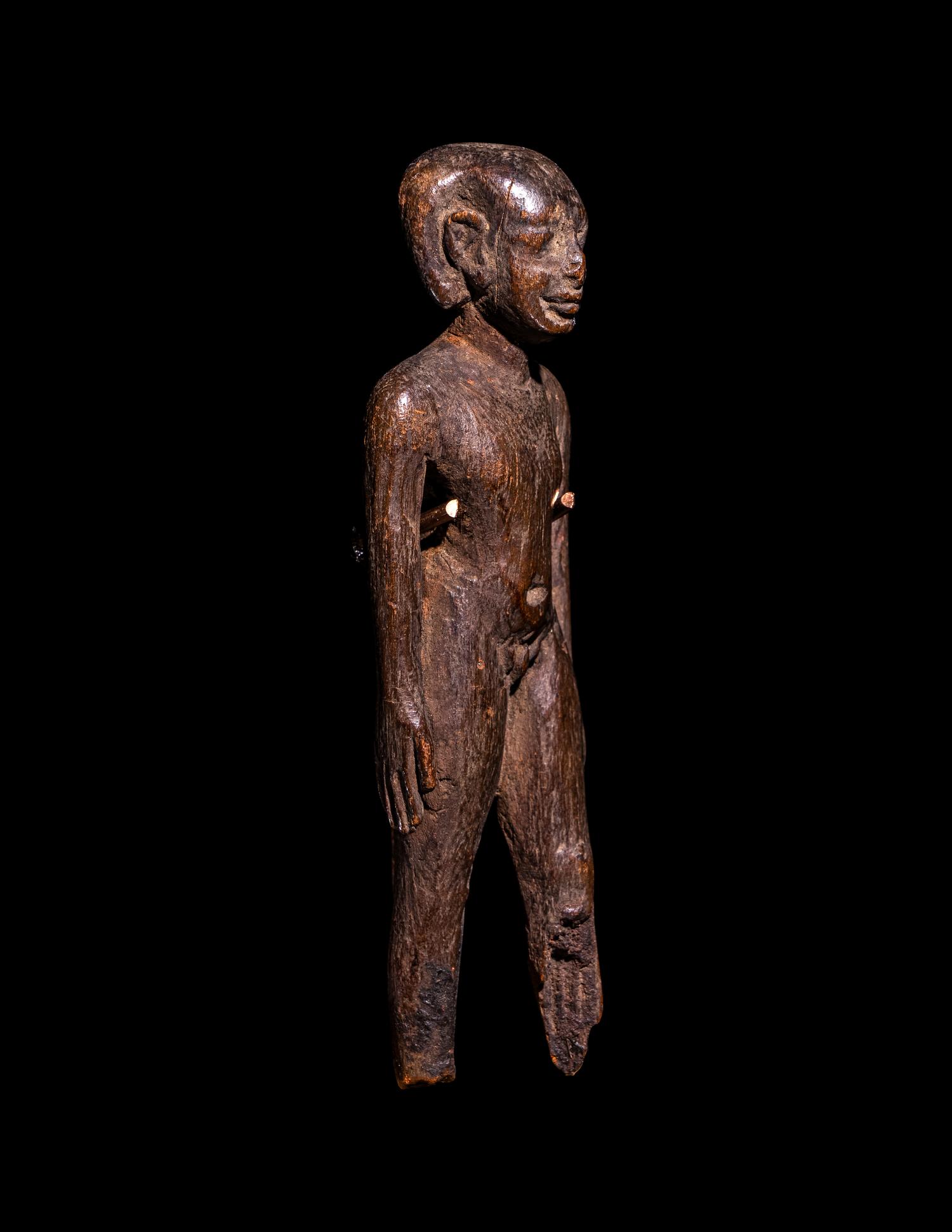 An Egyptian Wood Figure of a Youth