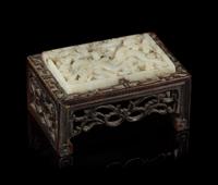A White Jade Inset Hardwood Ink Rest Length 2 3/4 x width 1 3/4 inches.