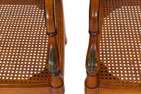 A Pair of Regency Style Paint Decorated and Parcel Ebonized Armchairs