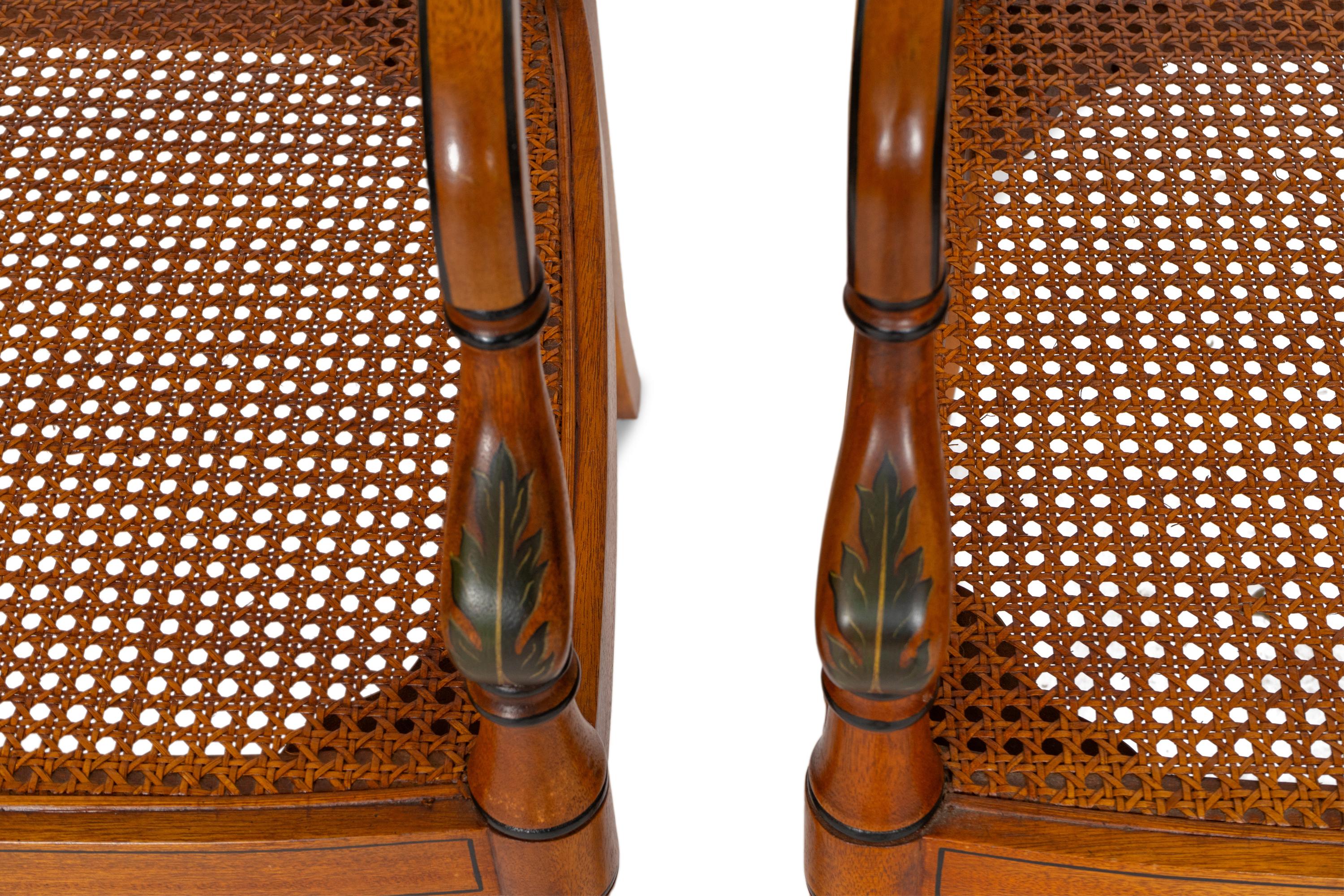 A Pair of Regency Style Paint Decorated and Parcel Ebonized Armchairs
