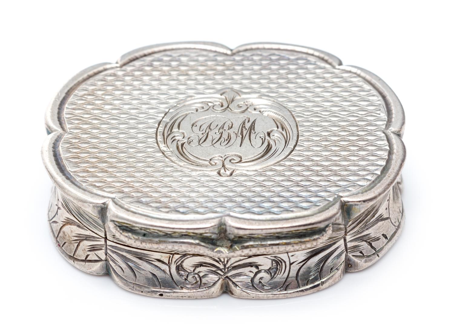 A Victorian Silver Vinaigrette, Edward Smith, Birmingham, 1857, of oval form with a scalloped rim, the sides worked with floral decorat