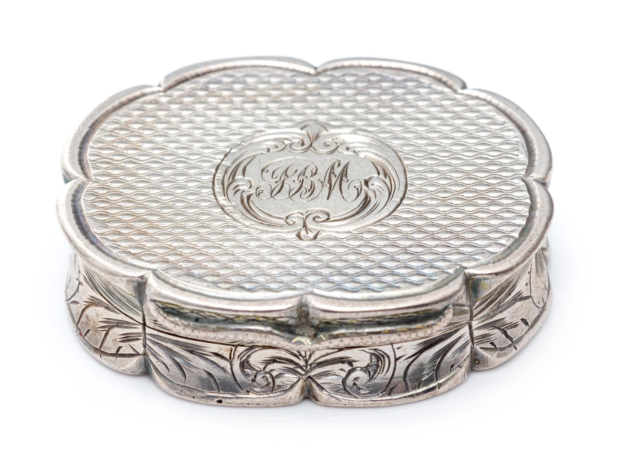 A Victorian Silver Vinaigrette, Edward Smith, Birmingham, 1857, of oval form with a scalloped rim, the sides worked with floral decorat