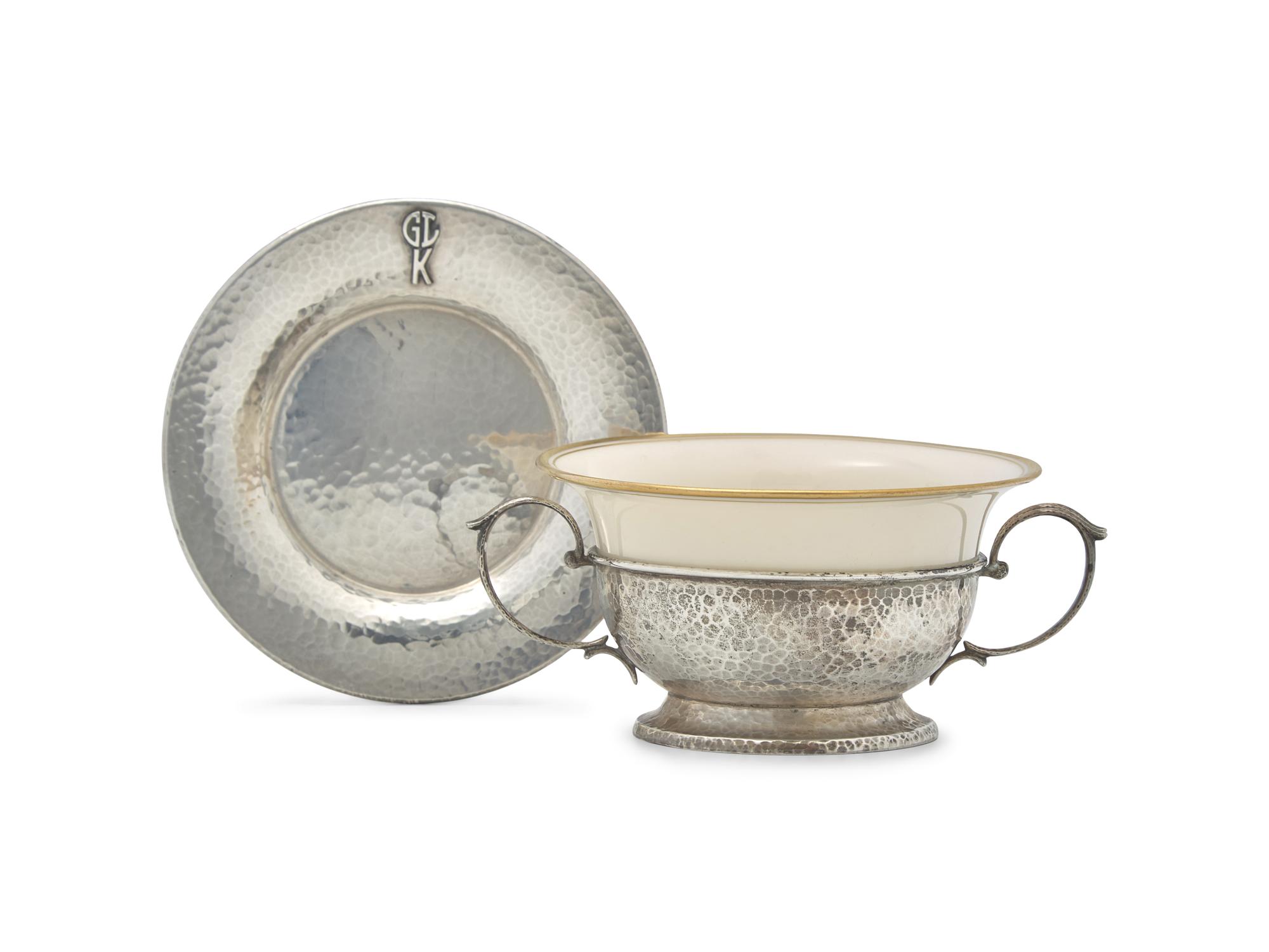 A Set of Twelve Arts & Crafts Hammered Silver Bouillon Cups And Saucers with Porcelain Liners