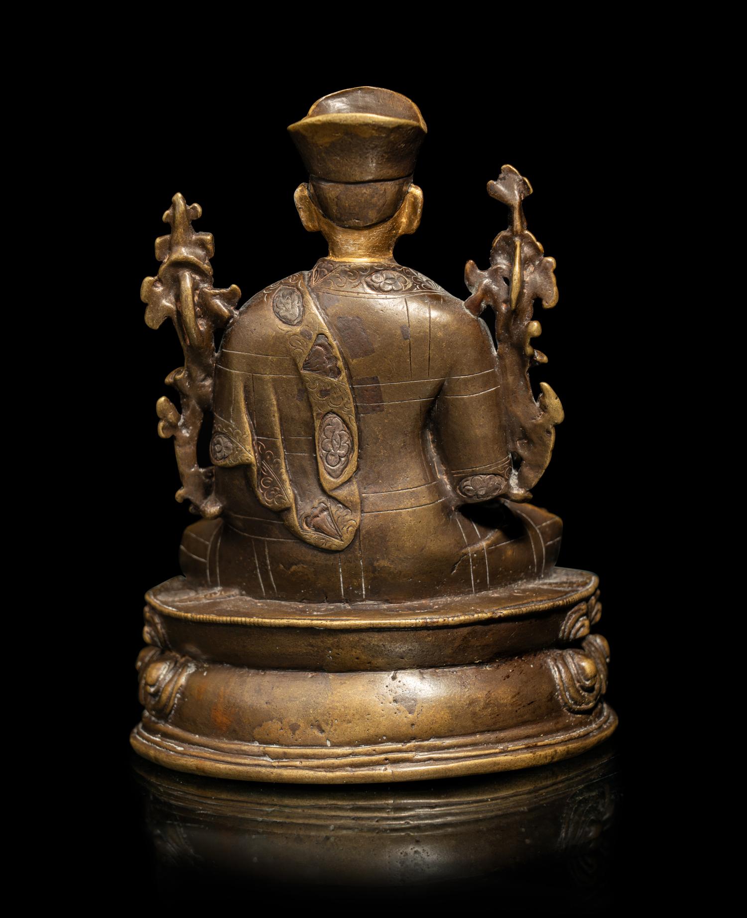 A Tibetan Parcel Gilt Bronze Figure of a Seated Lama