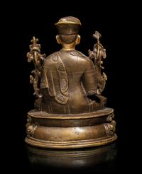 A Tibetan Parcel Gilt Bronze Figure of a Seated Lama