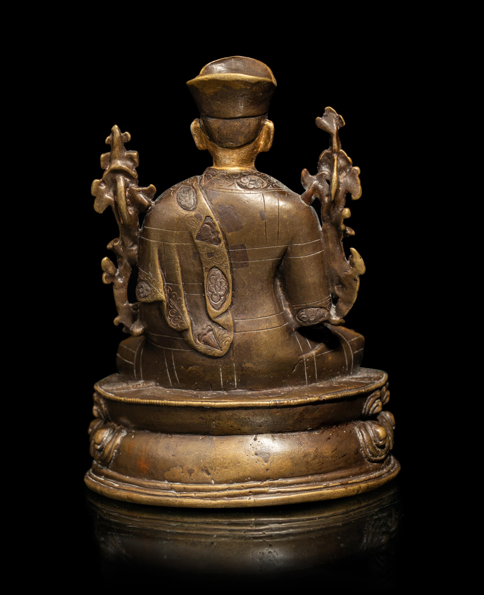 A Tibetan Parcel Gilt Bronze Figure of a Seated Lama