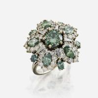 An irradiated green diamond, diamond, and white gold cocktail ring