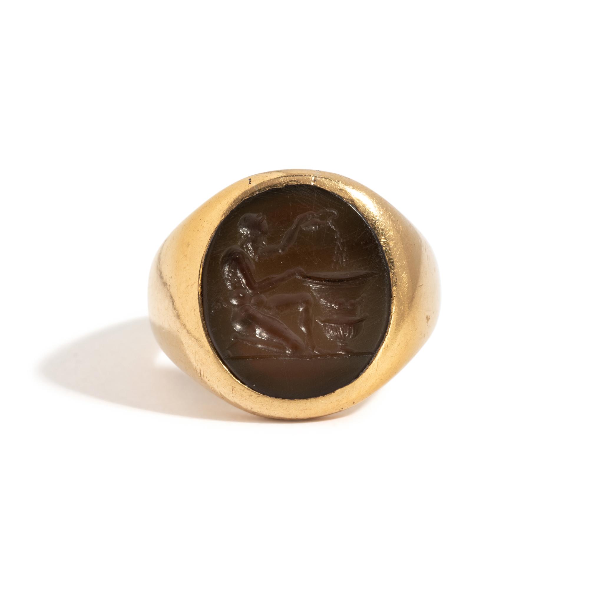 A Roman Carnelian Ring Stone with a Satyr Mixing Wine — Set in a gold ring
