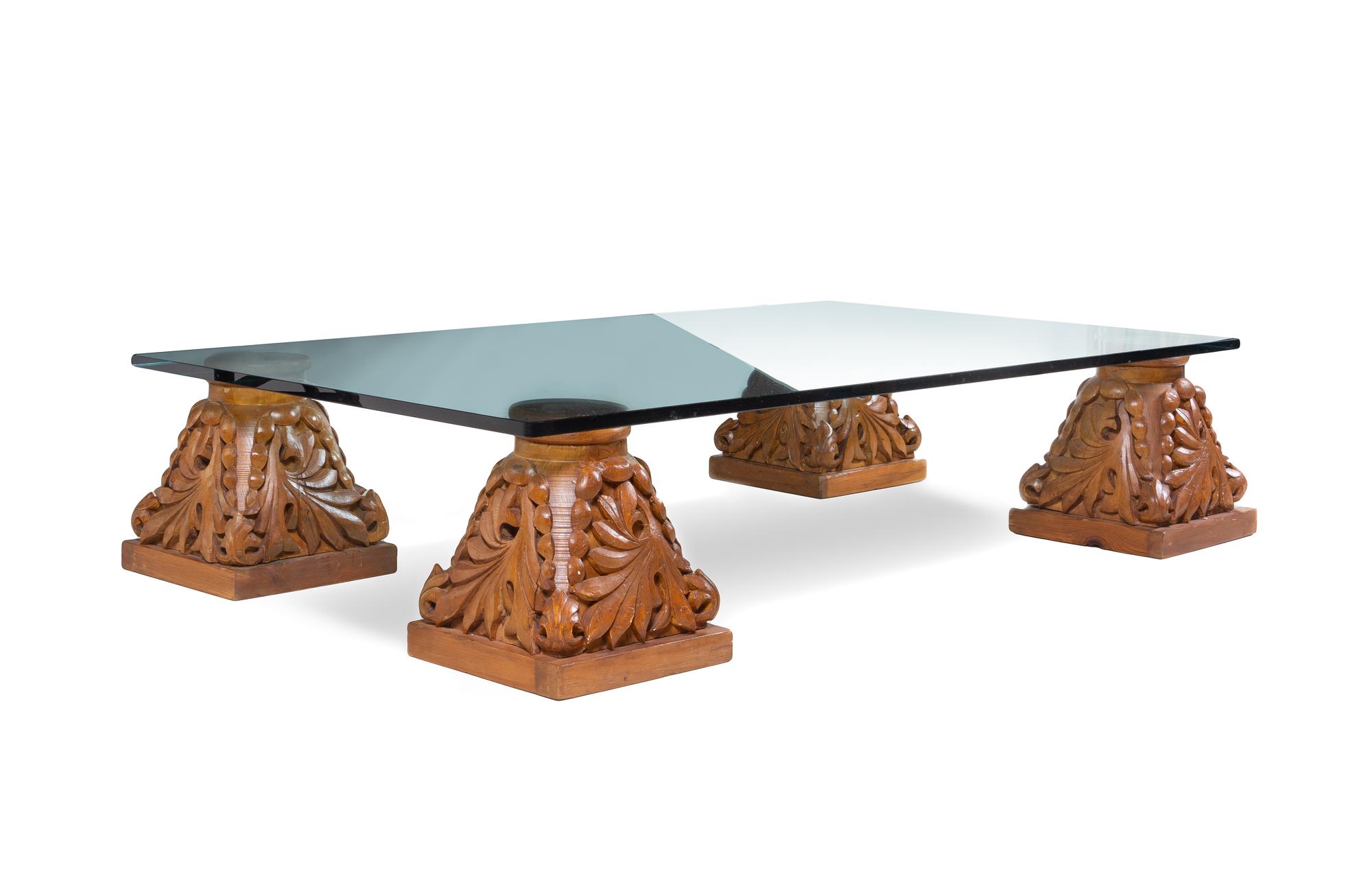 A Set of Four Carved Oak Capitals with a Glass Top as a Low Table