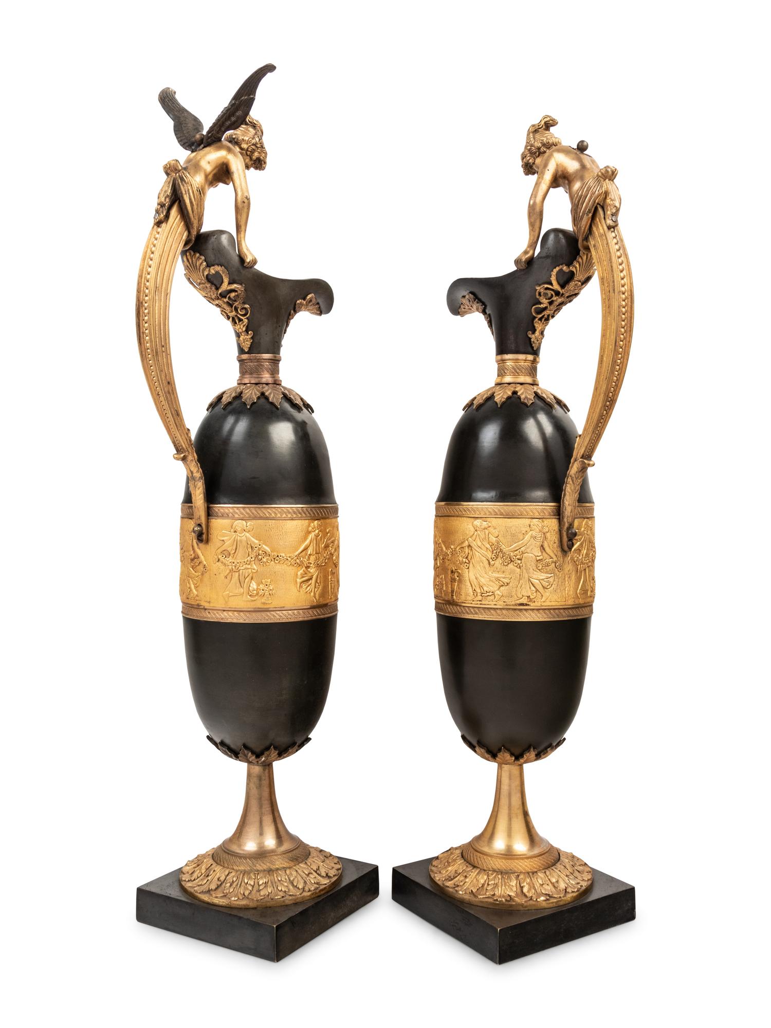 A Pair of Continental Gilt and Patinated Bronze Ewers