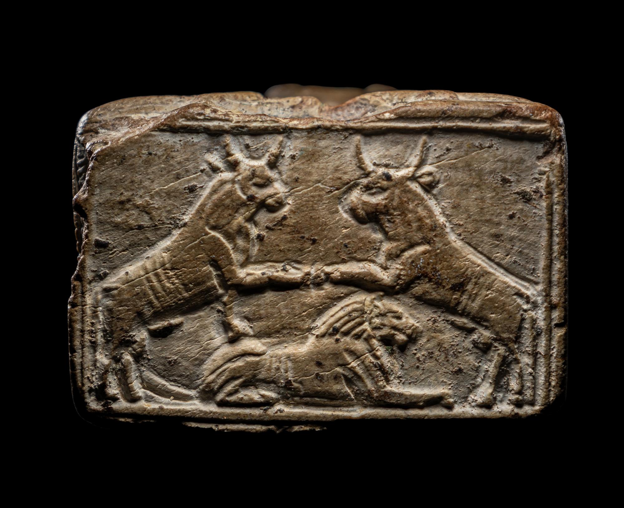 An Egyptian Glazed Steatite Amulet of Pataikos on Crocodiles