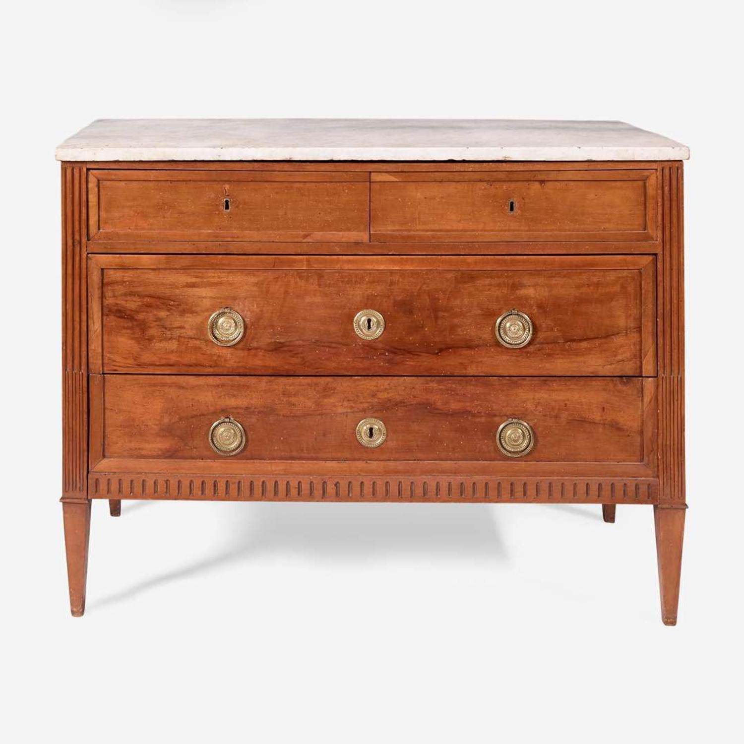A French Directoire carved fruitwood commode with white marble top circa 1800