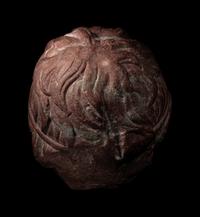 A Roman Rosso Antico Head of a Young Satyr