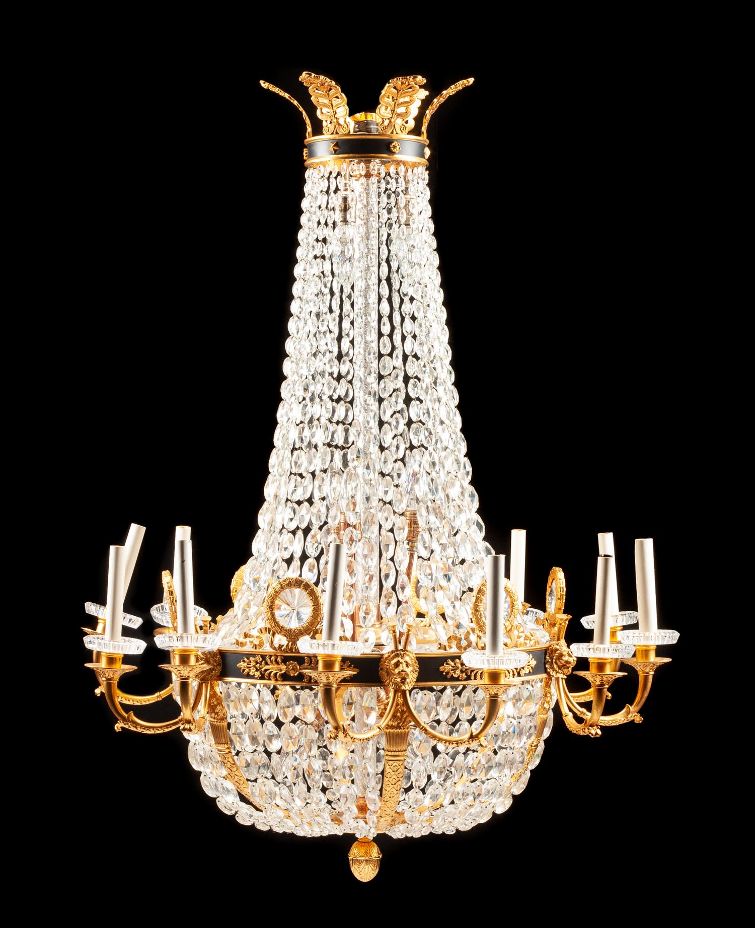 An Empire Style Gilt and Patinated Bronze Twelve-Light Chandelier Height 46 x diameter 35 inches.