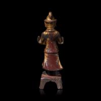 A Chinese Gilt and Lacquered Metal Figure of an Attendant, Ming Dynasty — 明 銅漆金文官像