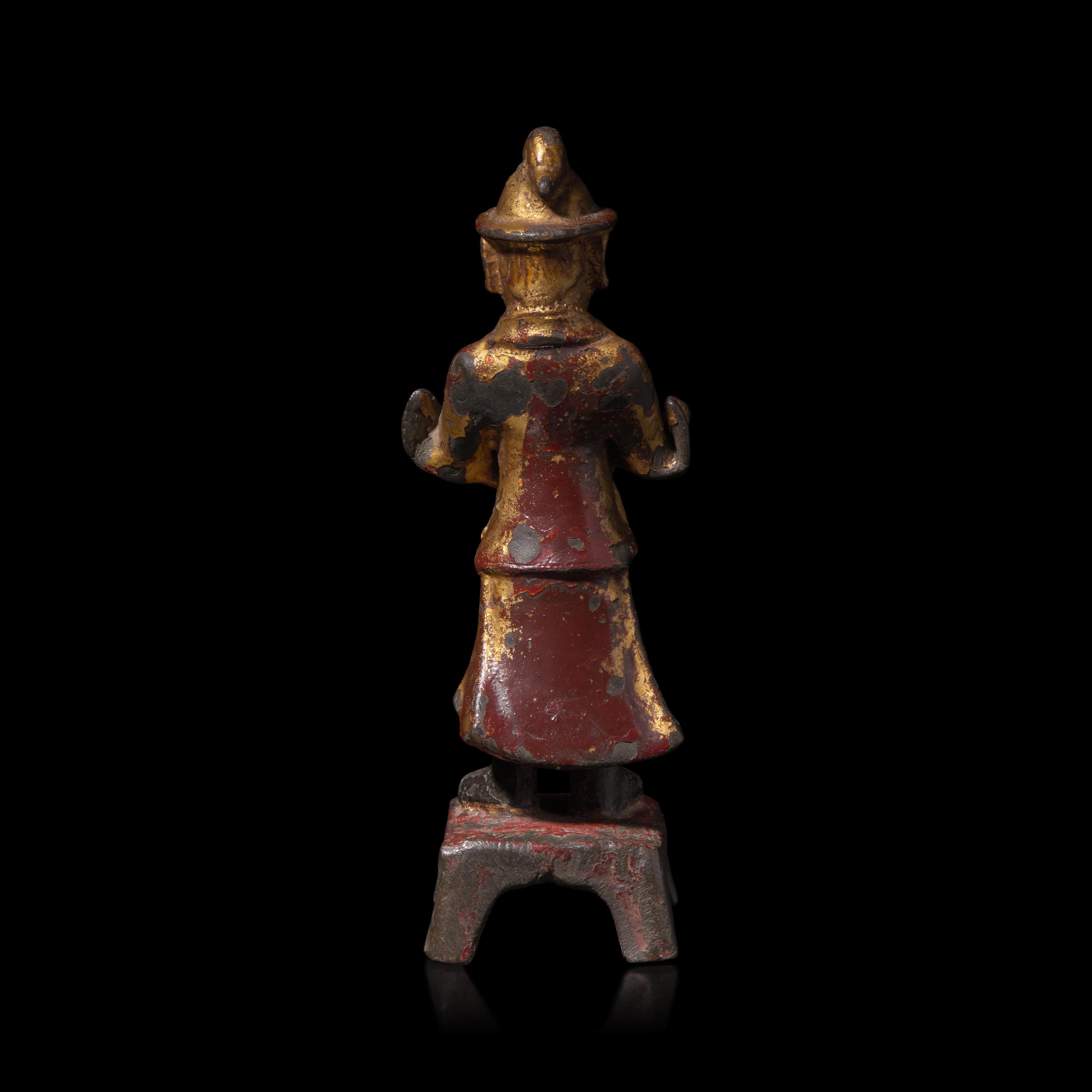 A Chinese Gilt and Lacquered Metal Figure of an Attendant, Ming Dynasty — 明 銅漆金文官像