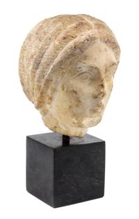 A Roman Marble Portrait Head of a Woman Height 9 1/4 inches. — CIRCA EARLY TO MID 3RD CENTURY C.E.