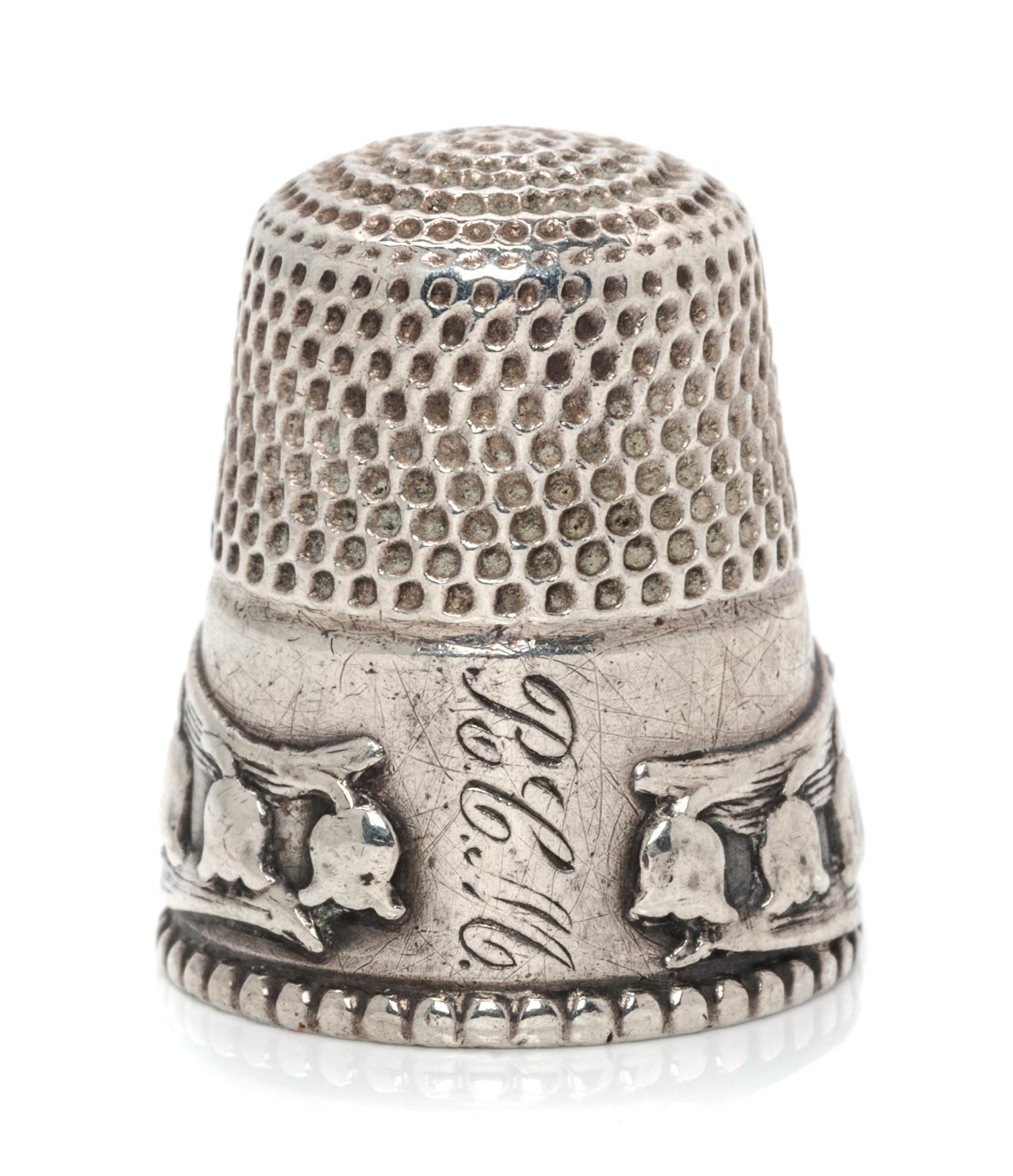 An American Silver Lily of the Valley Thimble, Stern Bros., Philadelphia, PA, the knurled top and body above a band worked to show ribb