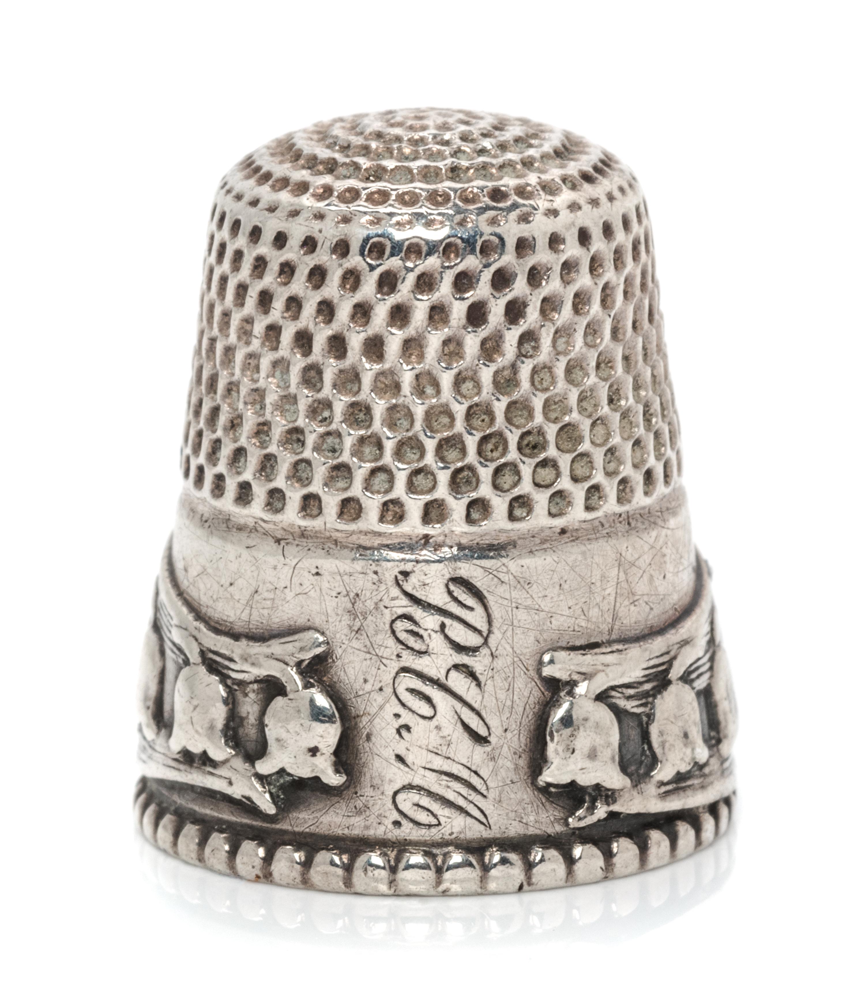 An American Silver Lily of the Valley Thimble, Stern Bros., Philadelphia, PA, the knurled top and body above a band worked to show ribb