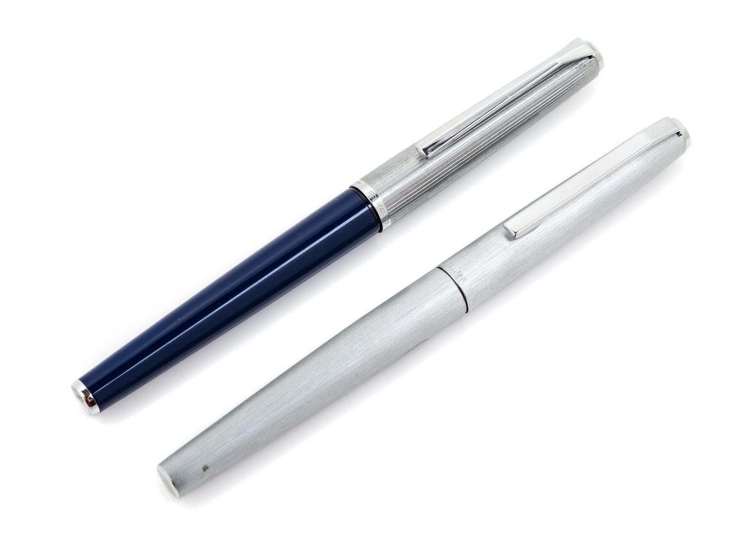 Two Pelikan Silvexa Fountain Pens Length of each 5 1/4 inches.