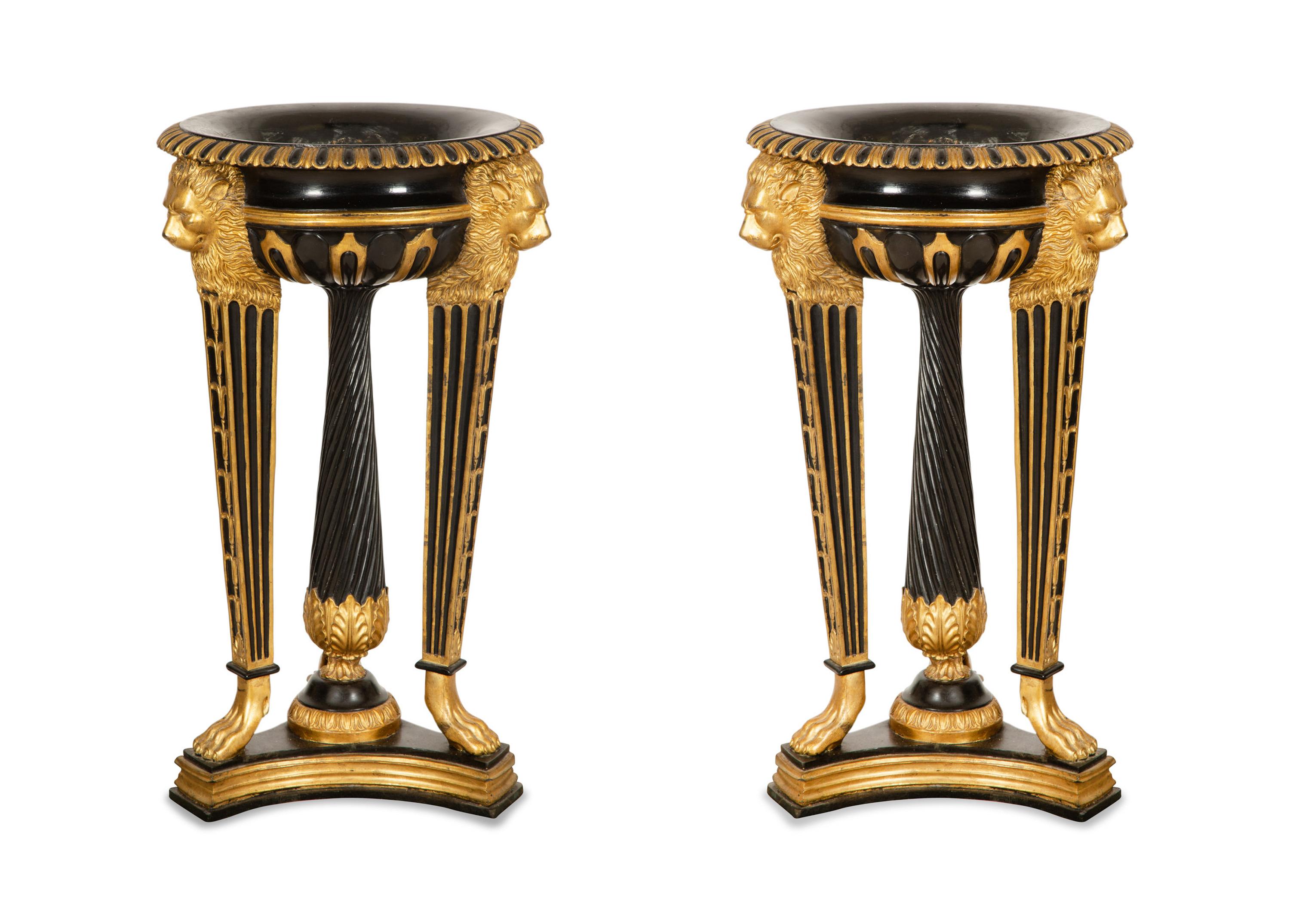 A Pair of Neoclassical Style Ebonized and Parcel Gilt Composition Jardinières on Stands