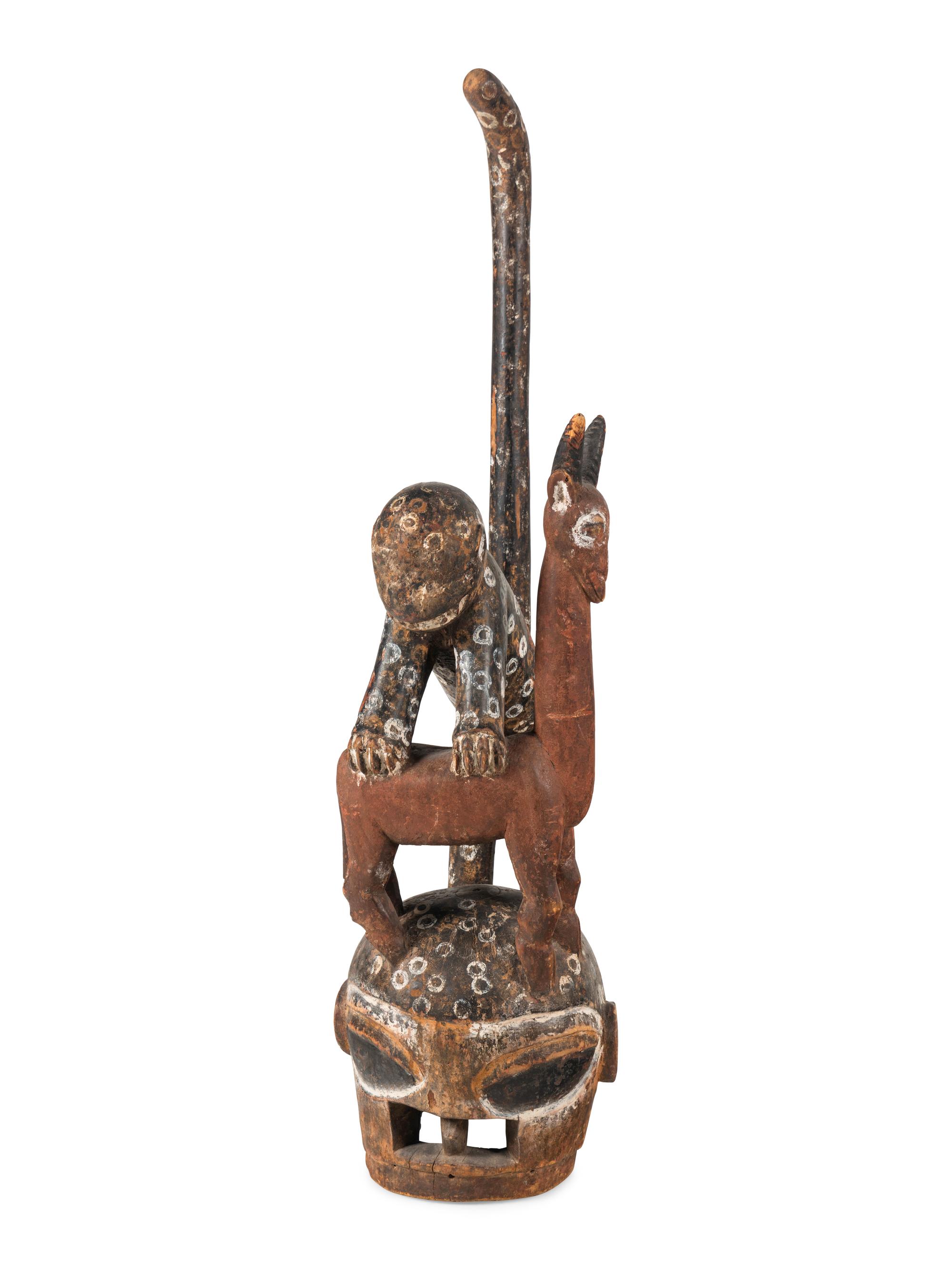 An African Carved and Painted Wood Monkey and Gazelle Figural Group