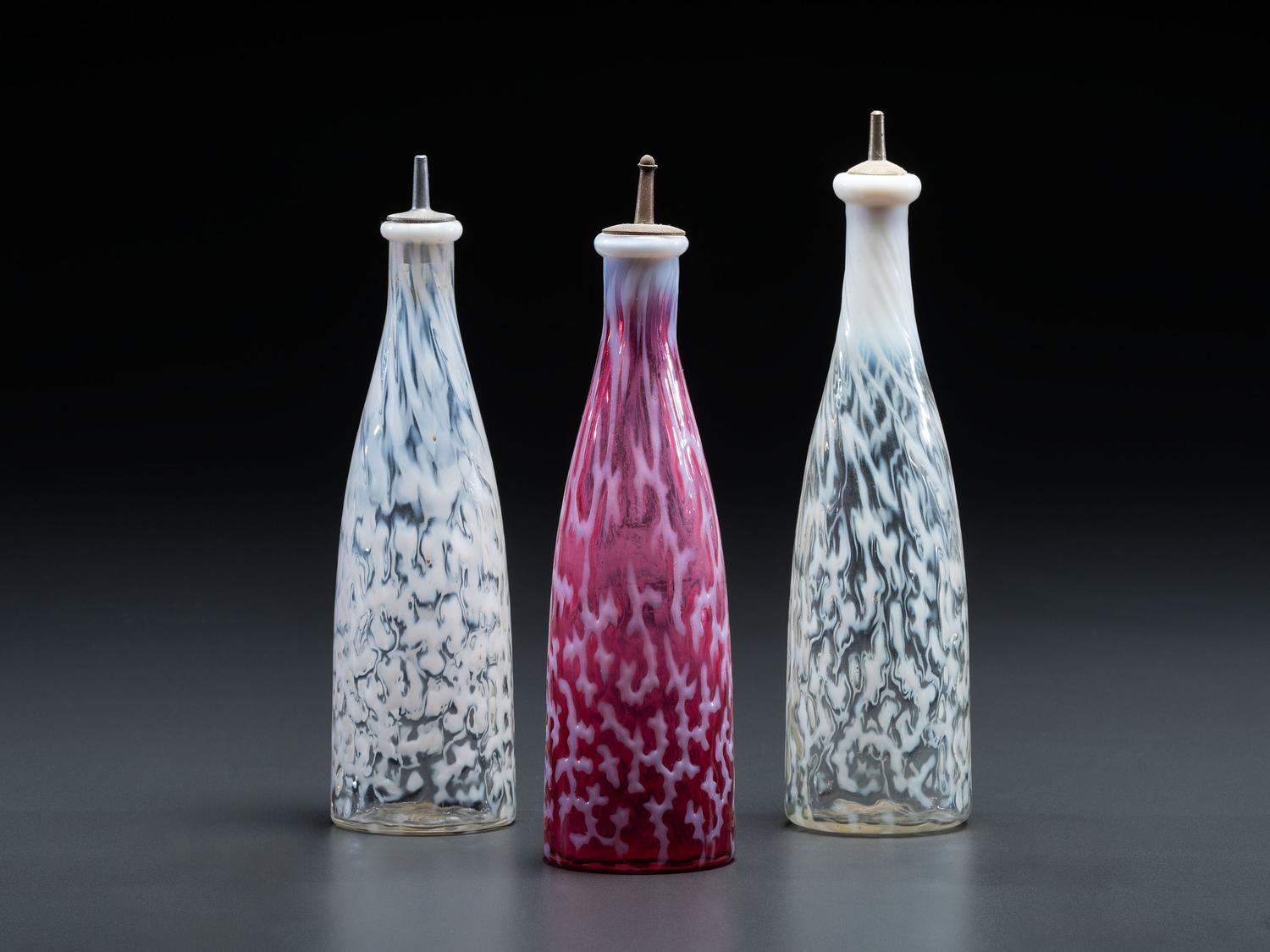 Three Coral Opalescent Glass Barber Bottles