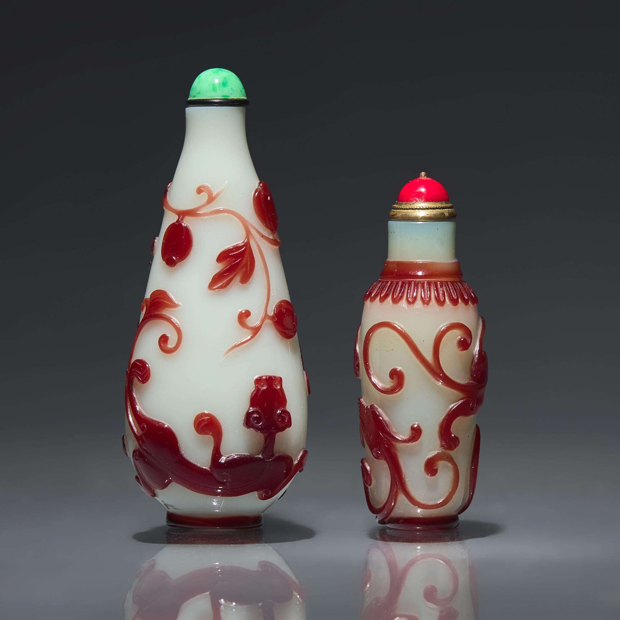 Two Chinese Ruby-Overlay Glass Bottles, Qing dynasty, Circa 1770-1880 — 1770-1880年 白地套寶石紅料螭龍紋鼻煙壺兩支