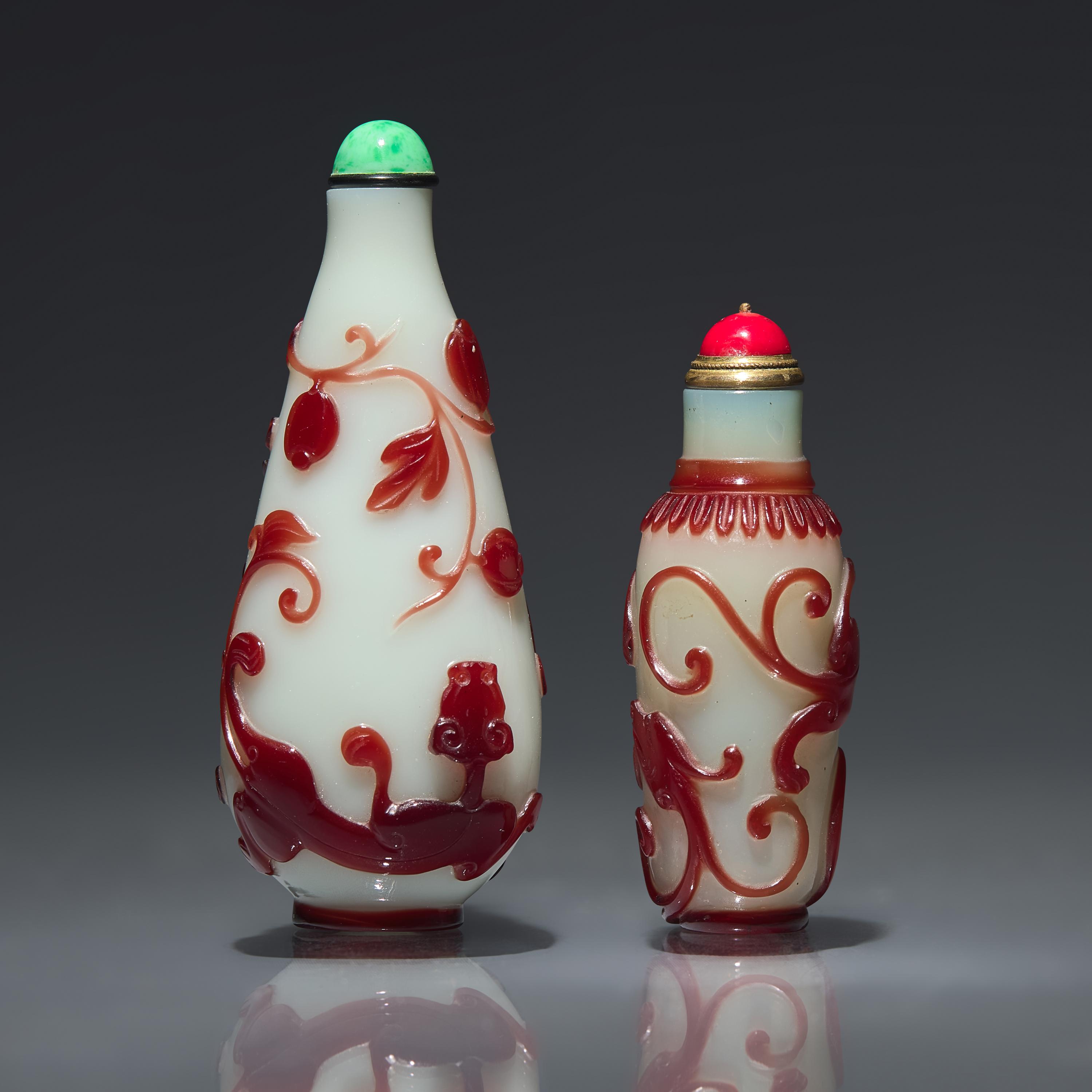 Two Chinese Ruby-Overlay Glass Bottles, Qing dynasty, Circa 1770-1880 — 1770-1880年 白地套寶石紅料螭龍紋鼻煙壺兩支