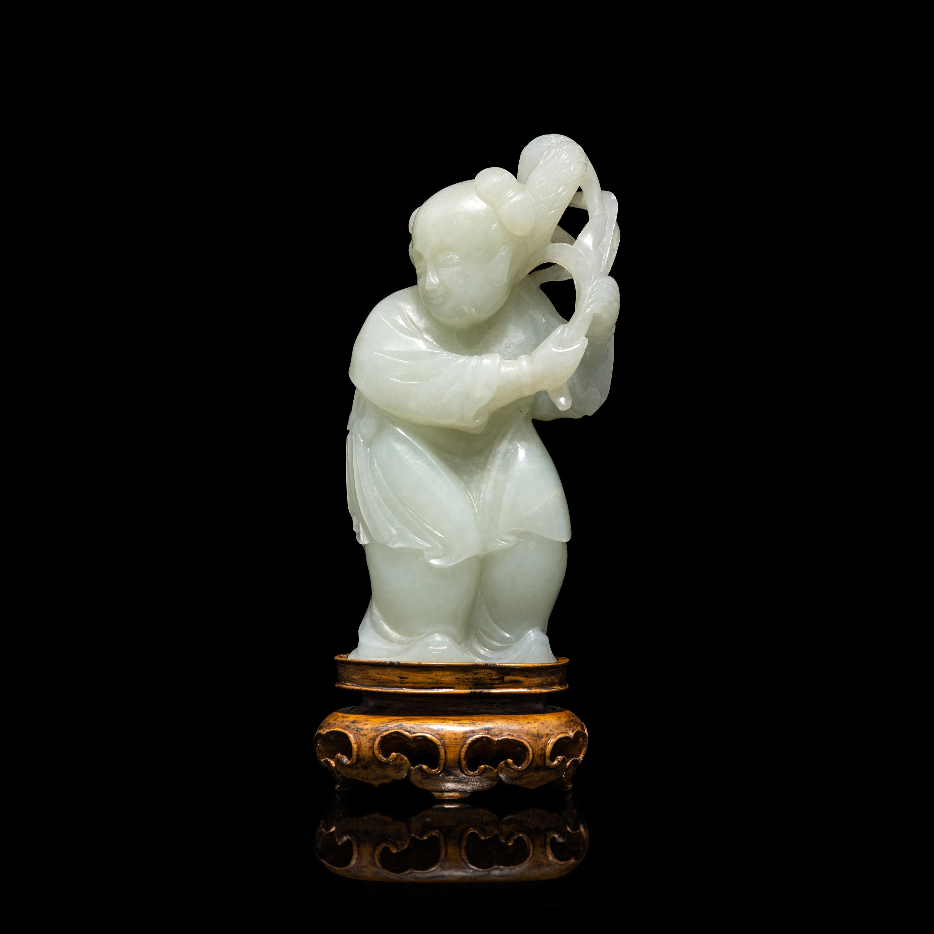 A Chinese Pale Celadon Jade Figure of a Boy, 18th-19th Century 清中期 青白玉 持蓮 童子