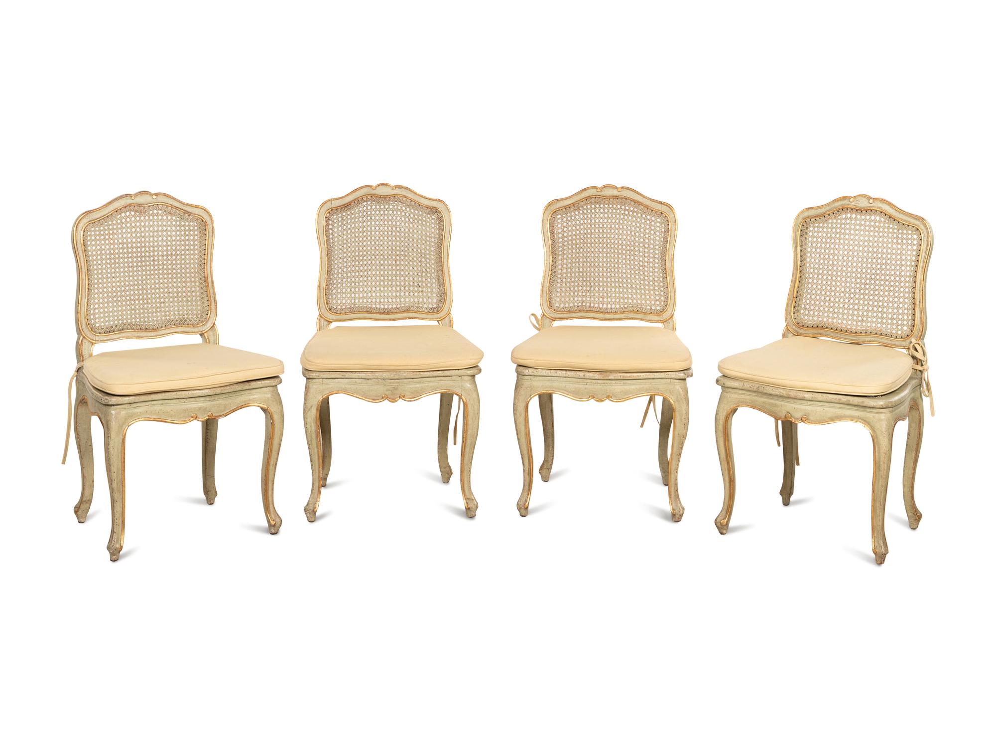 A Set of Four Louis XV Style Painted and Parcel Gilt Dining Chairs