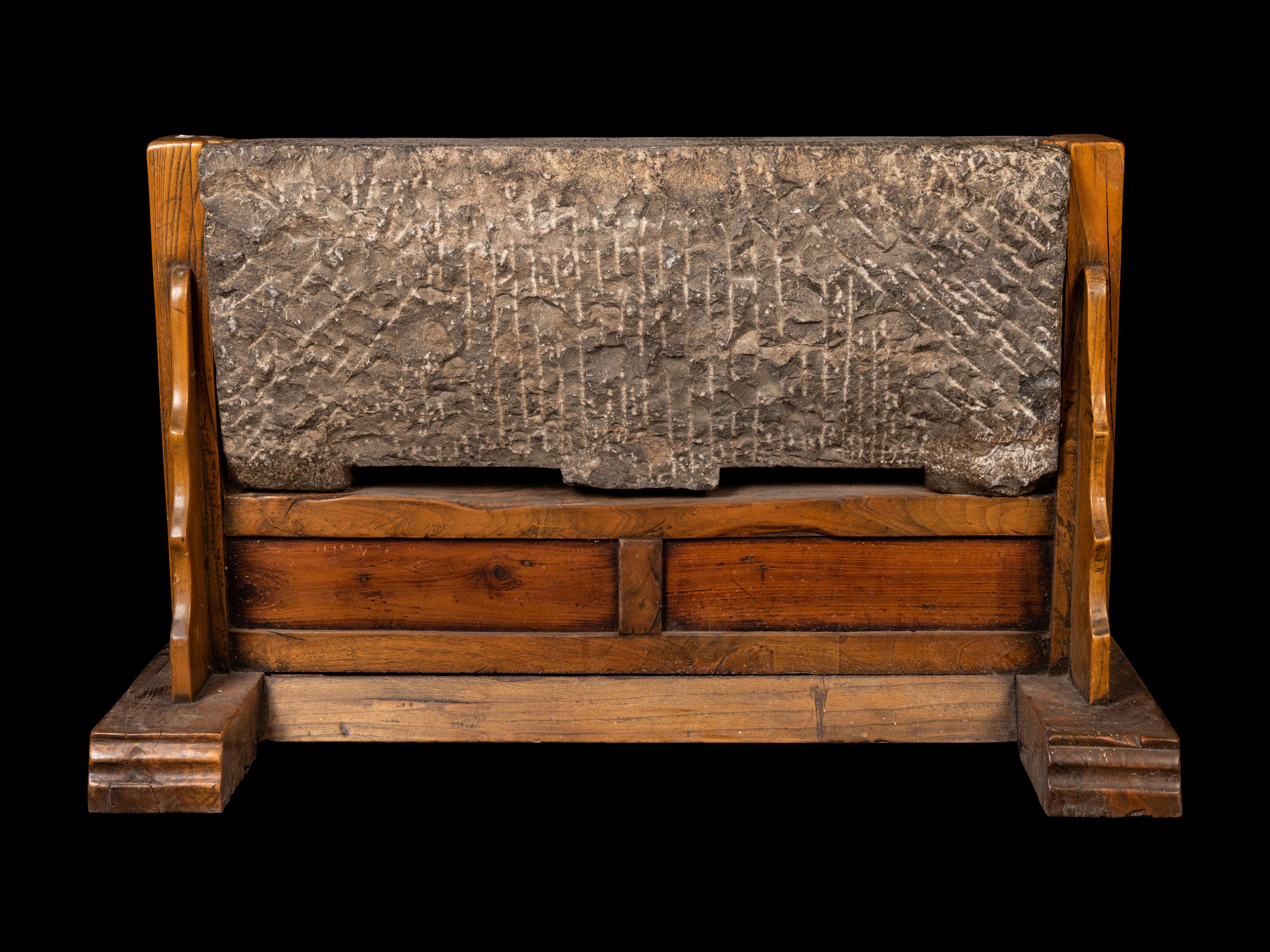 A Chinese Relief Carved Stone Stele Panel on Fitted Wood Stand
