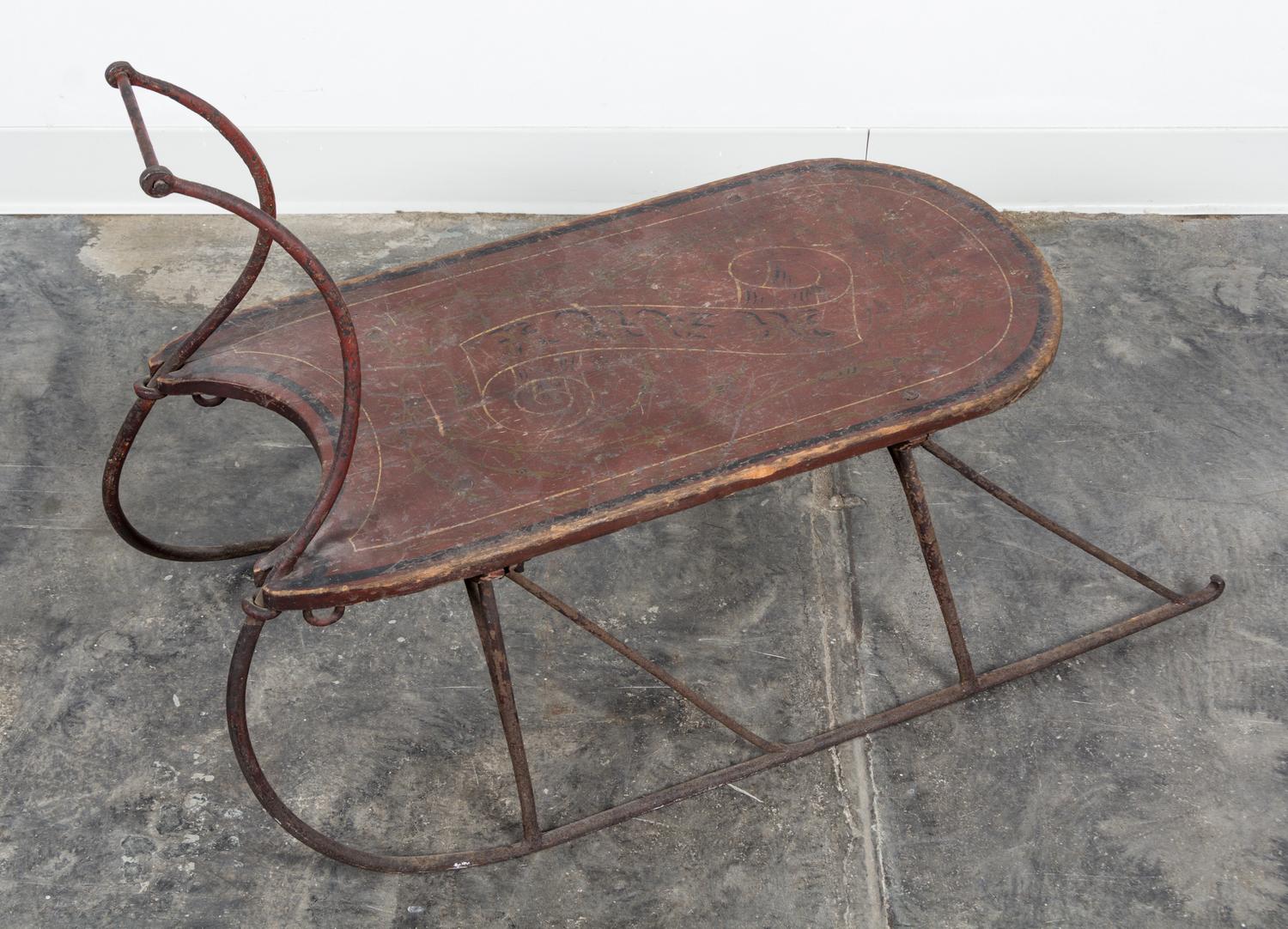 A Painted Wood and Metal Sled. Length overall 33 1/2 inches.