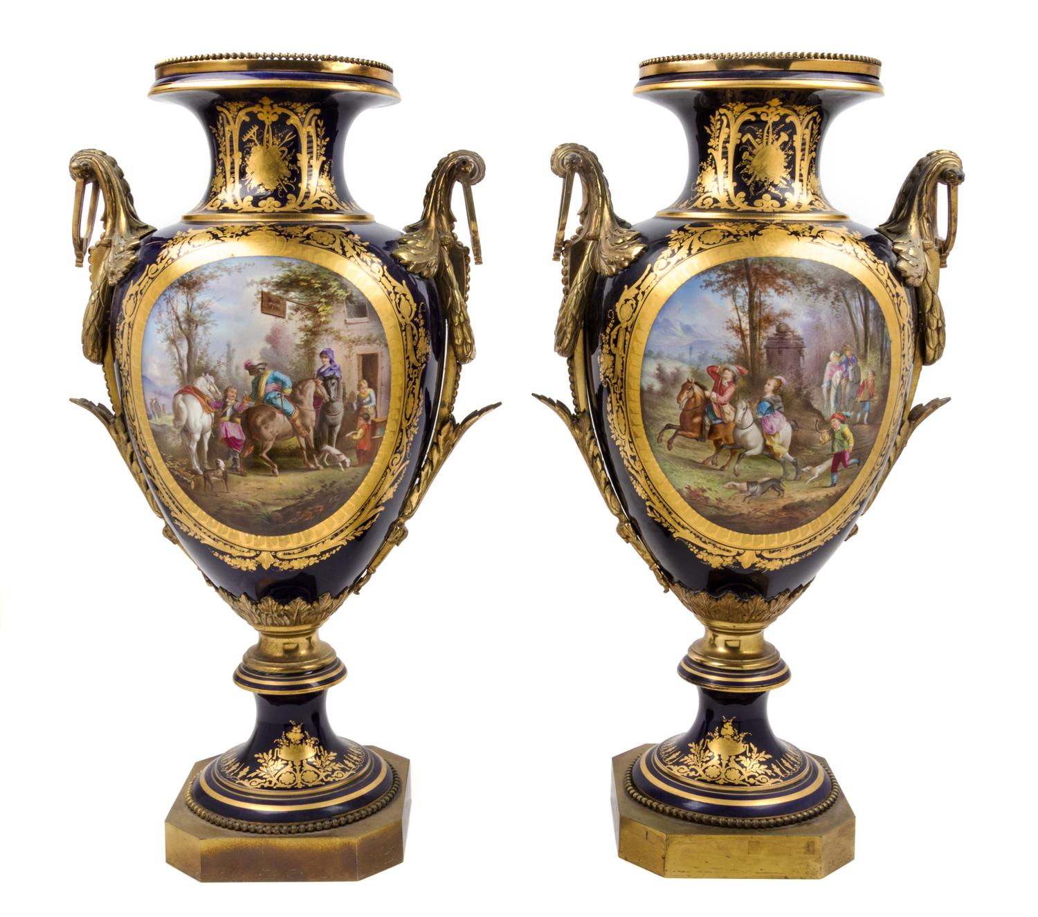 A Pair of Sevres Gilt Bronze Mounted Porcelain Urns Height 30 inches.