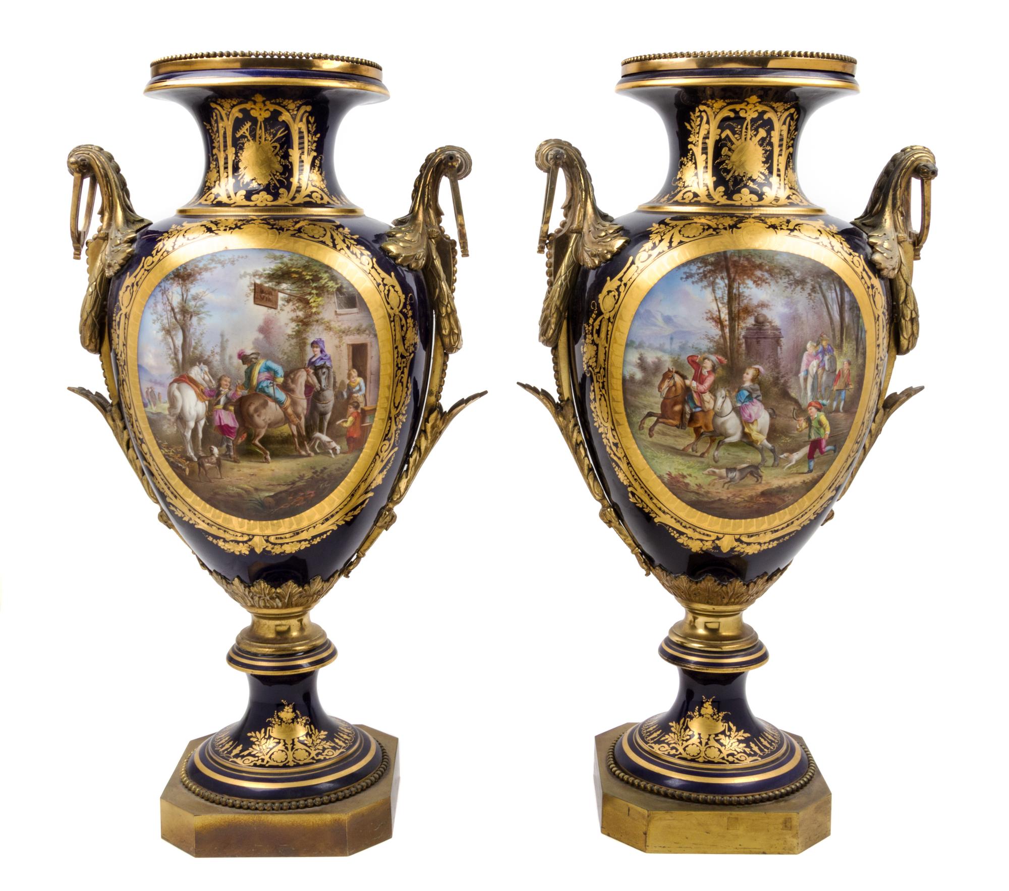A Pair of Sevres Gilt Bronze Mounted Porcelain Urns Height 30 inches.