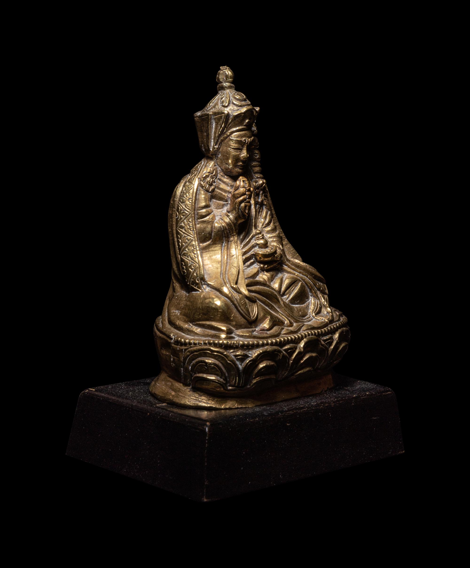 A Tibetan Gilt Bronze Figure of a Priest