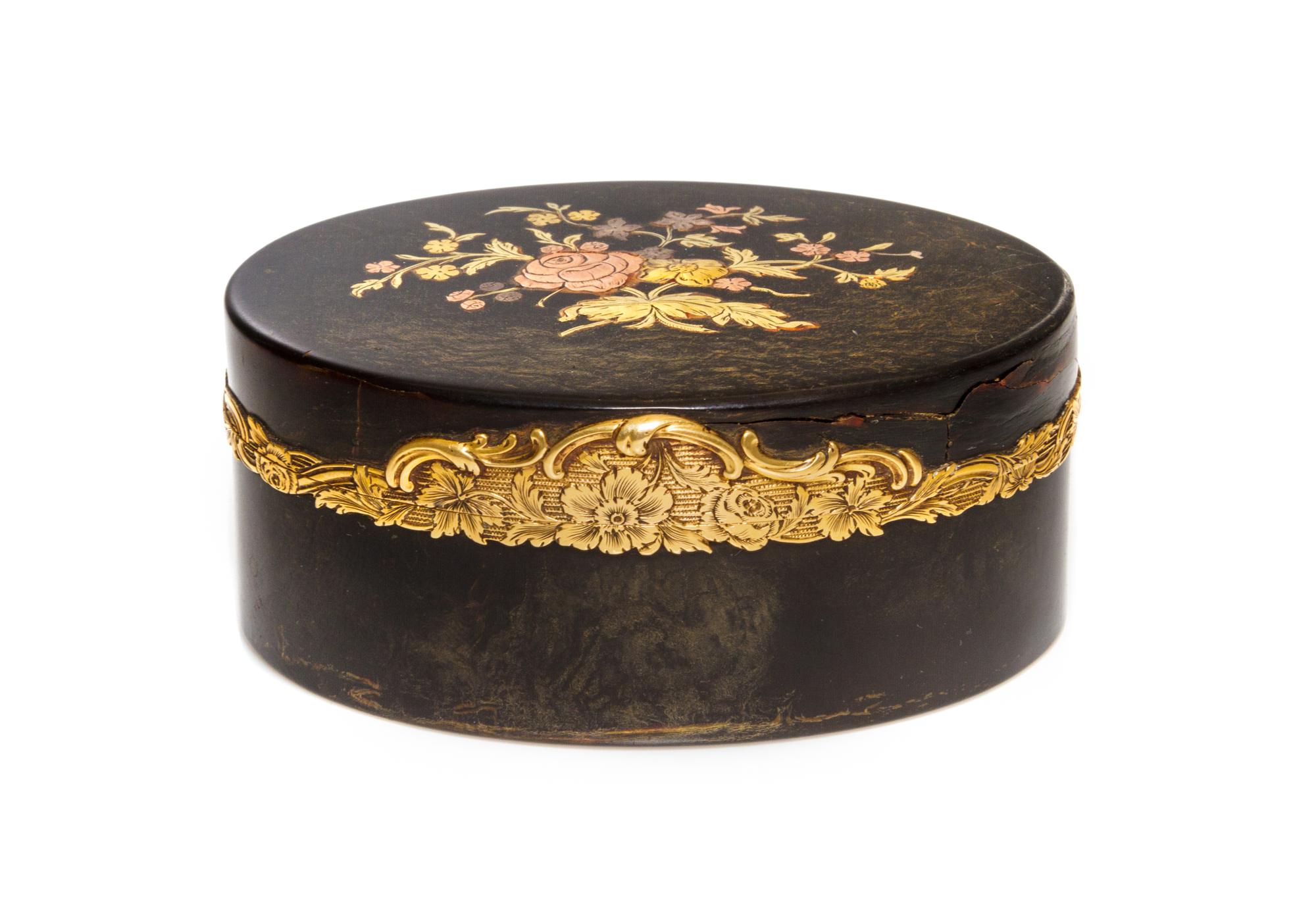 A Georgian Gilt Metal Mounted Snuff Box, 18th/19th Century, of oval form with hinged lid, having floral inlays and banding.