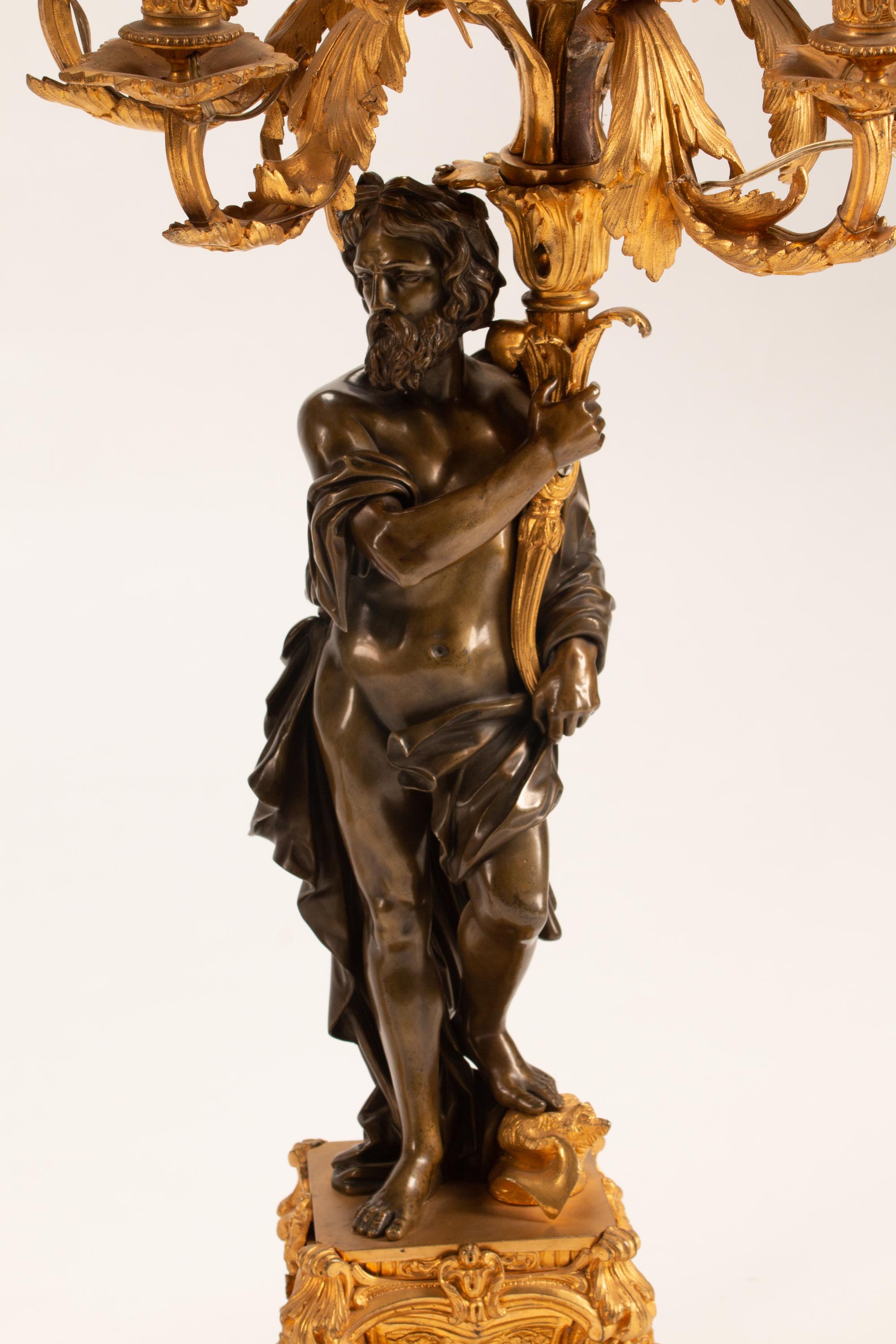 A Pair of Parcel-Gilt and Patinated Bronze Figural Eight-Light Candelabra — 19TH CENTURY