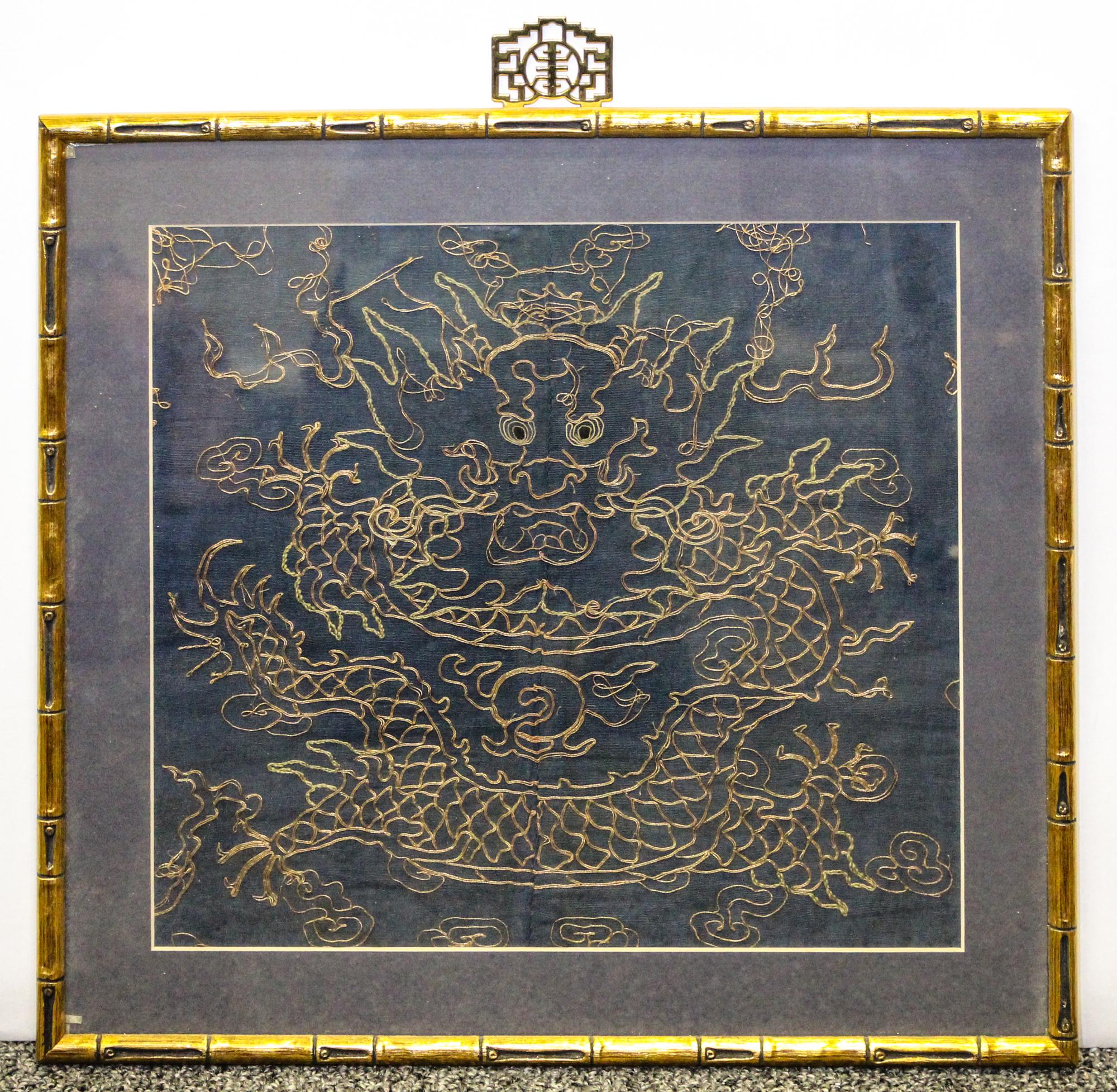 An Unfinished Framed Embroidery of a Dragon Height 12 x width 13 1/4 inches.