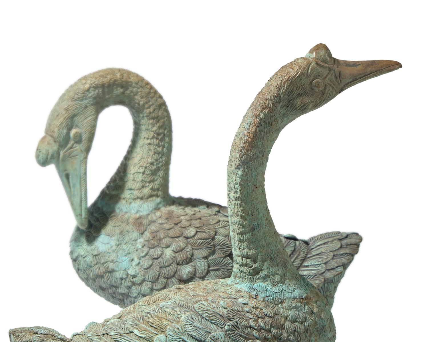 A pair of cast zinc garden statues of geese, 20th century